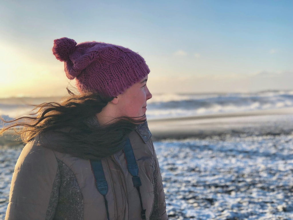 A woman in a winter beach outfit