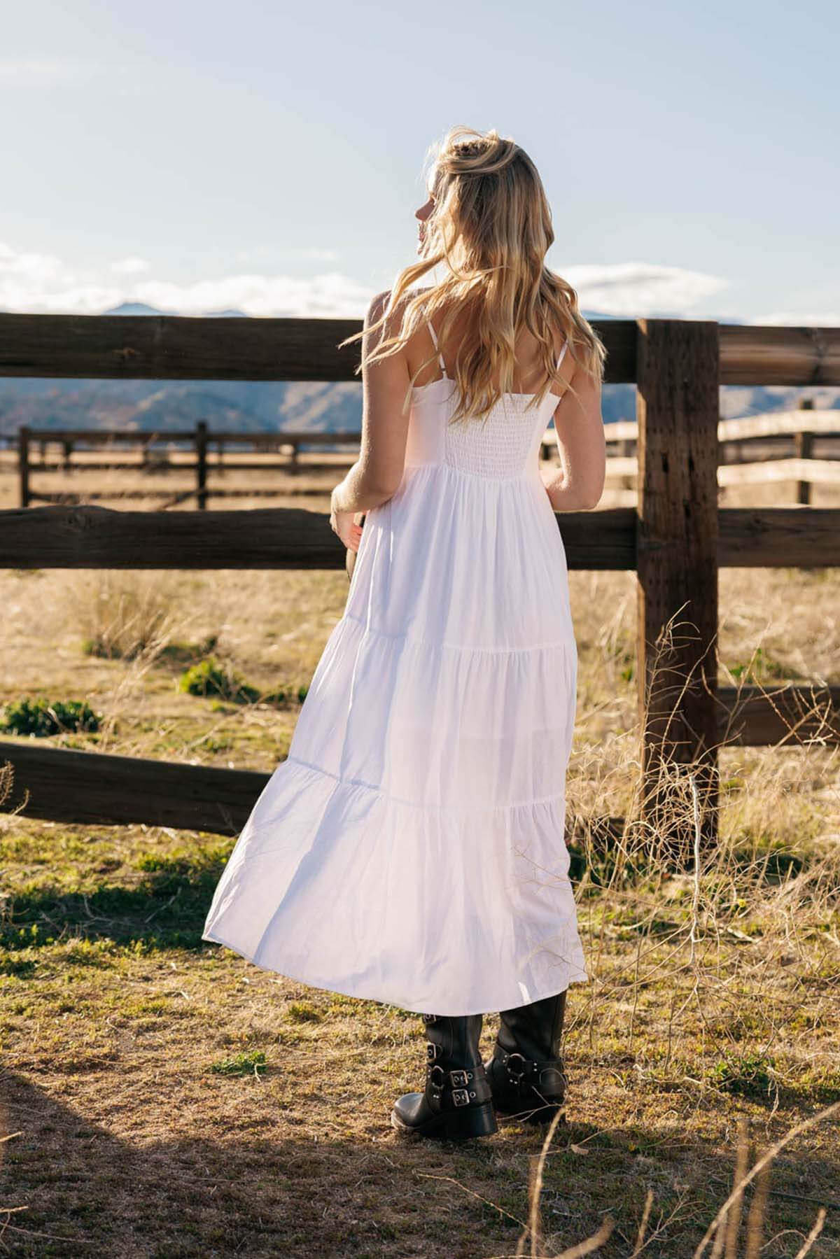 Woman wearing a white linen tiered maxi dress