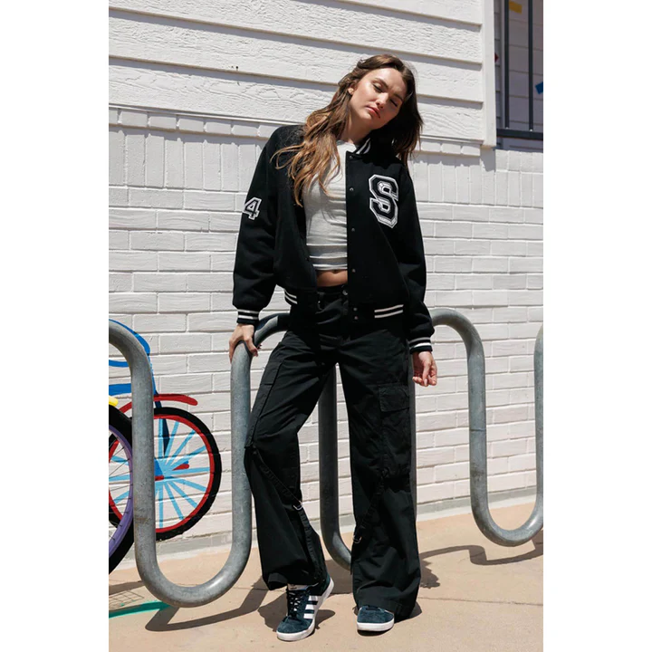 Woman wearing a black varsity bomber everyday jacket