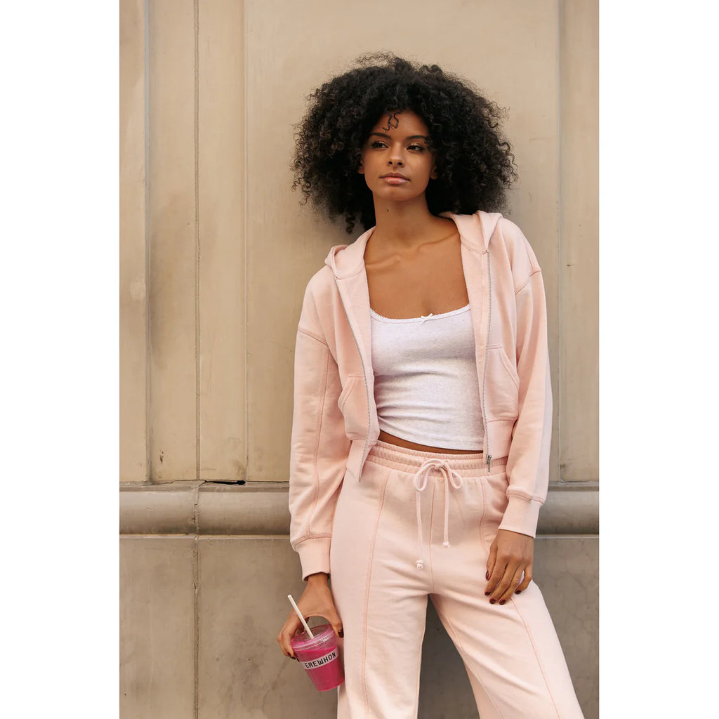 Woman in a casual matching pink athleisure outfit