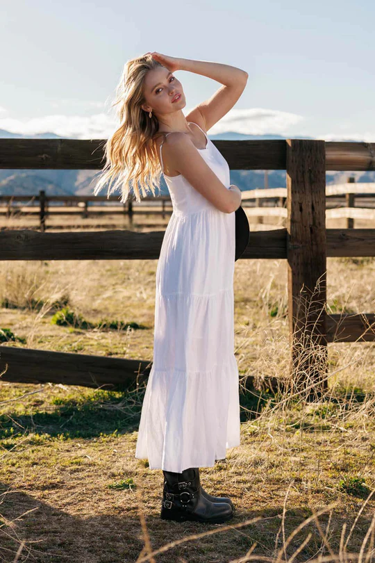 Woman in a white maxi dress coastal cowgirl outfit