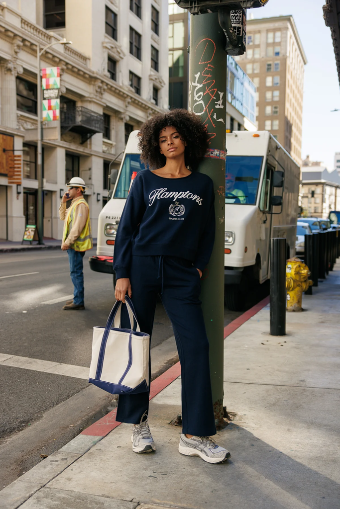 A woman wearing Cali1850 graphic fleece-lined sweatpants