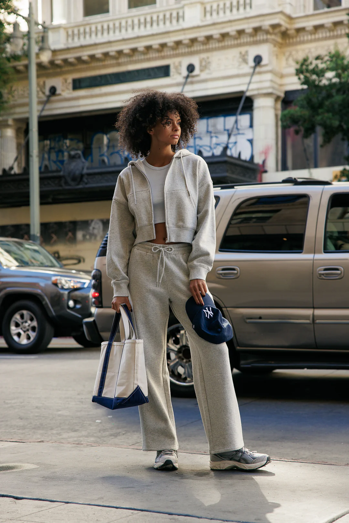 A woman wearing Cali1850 cozy sweatpants in light grey