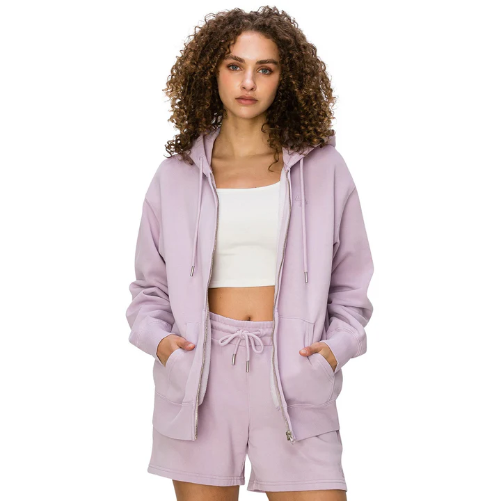 Woman in a lilac hoodie and matching shorts