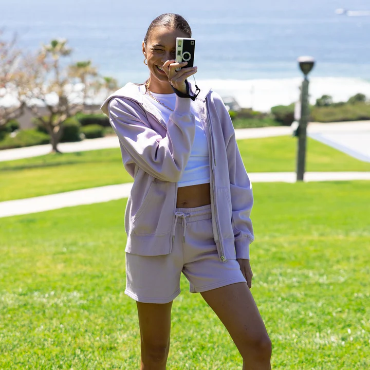 Woman in a lilac zip-up hoodie and shorts