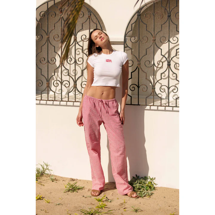 Woman in red pants & a white tee