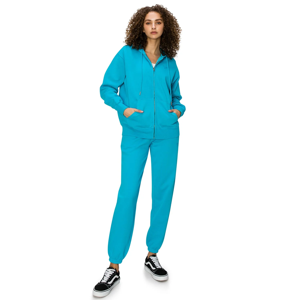 Woman in a teal zip-up hoodie and sweatpants