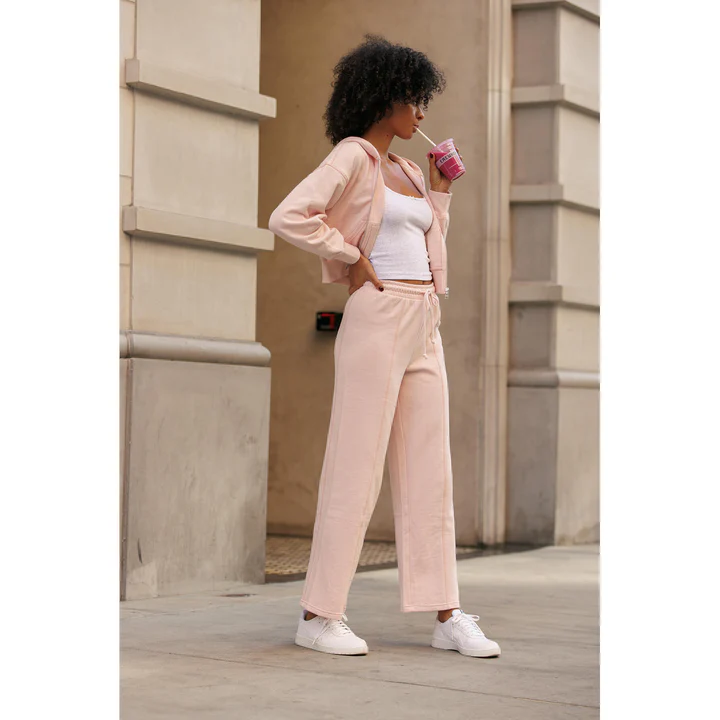 Woman in vintage pink sweatpants and a hoodie