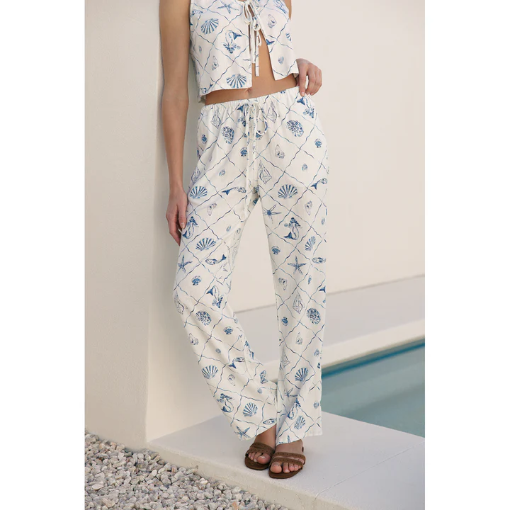Woman wearing white & light blue printed linen pants