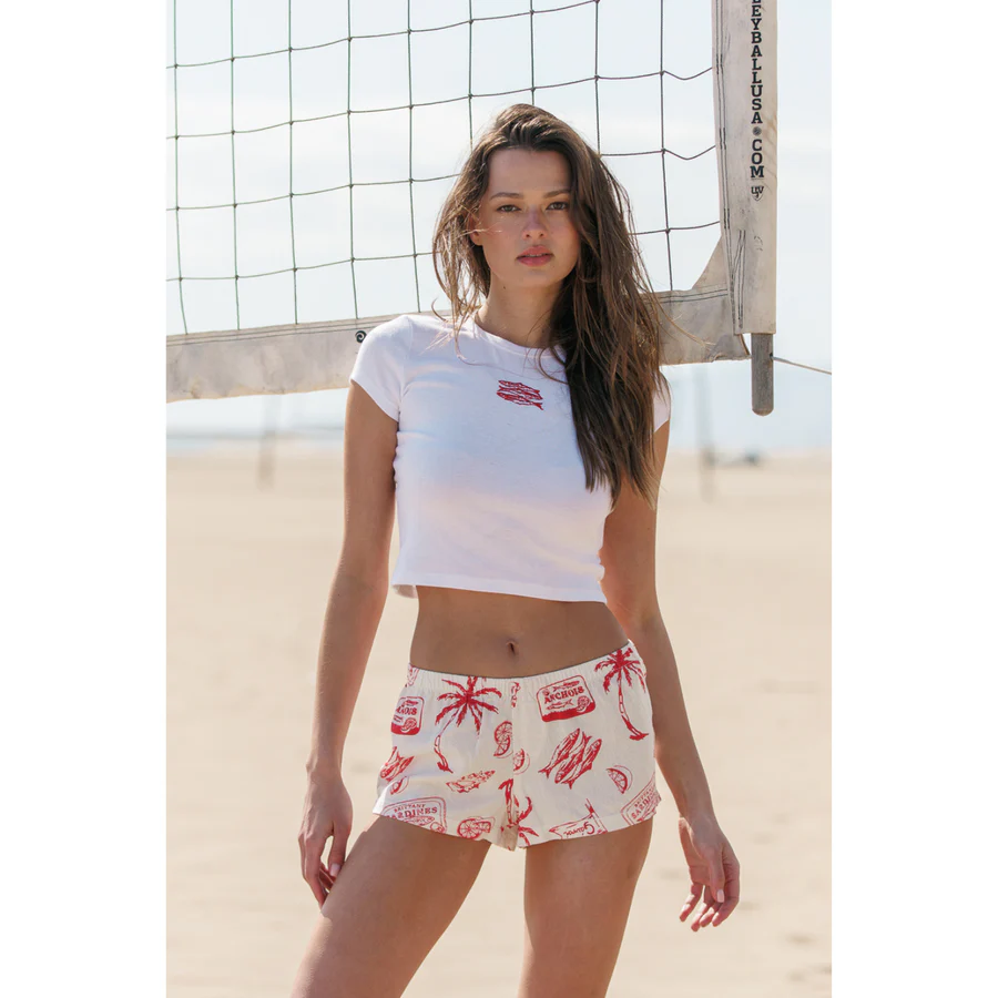 Woman at the beach in a white & red linen set