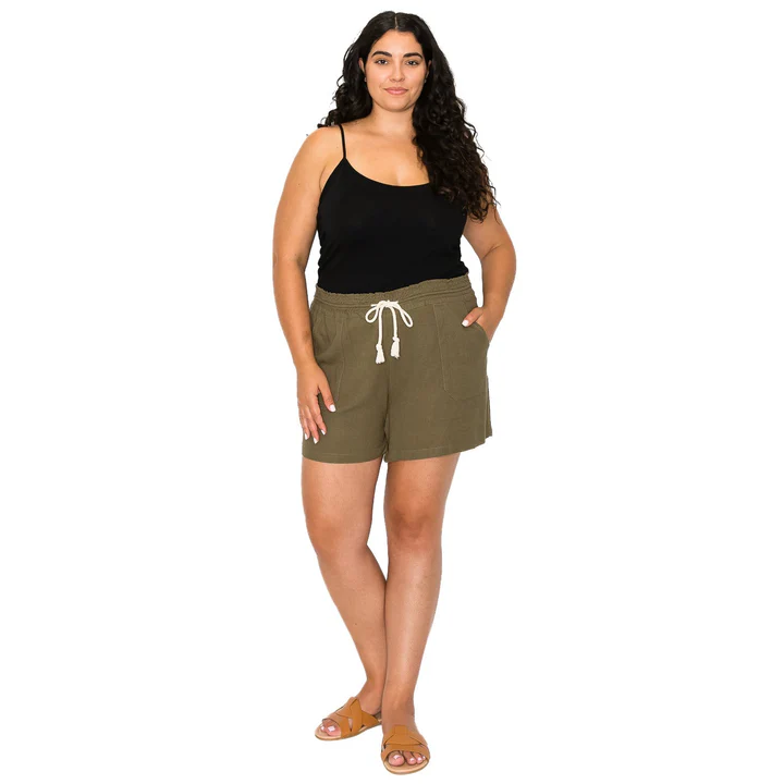 A woman wearing olive shorts and a black tank top