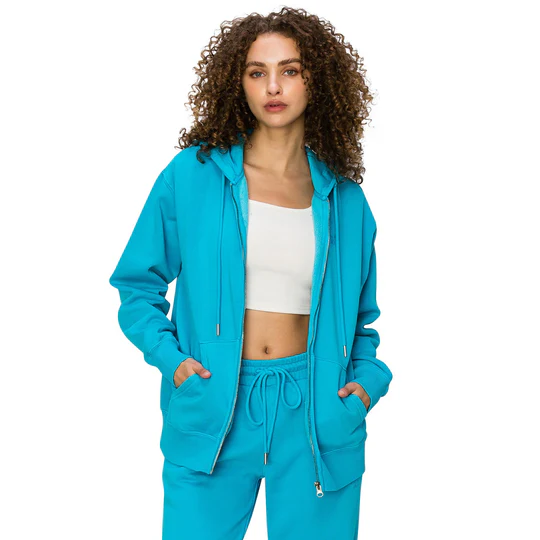 A model in a women’s teal hoodie and sweatpants