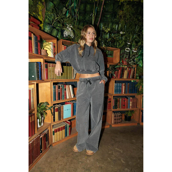 A model wearing women’s vintage sweatpants and a sweatshirt